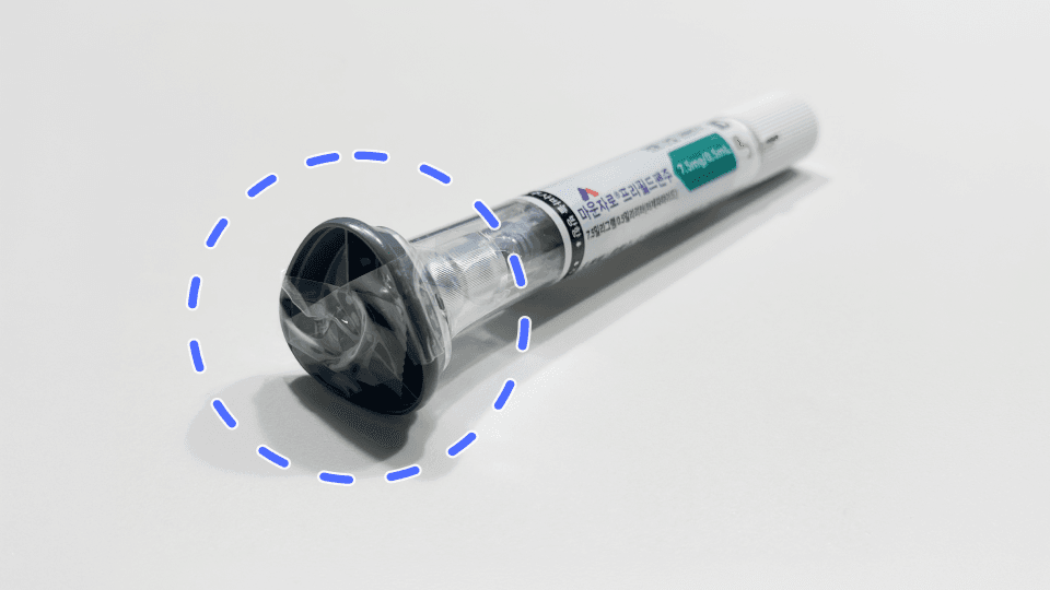 A used-up Mounjaro pen with its cap safely sealed shut with clear tape.