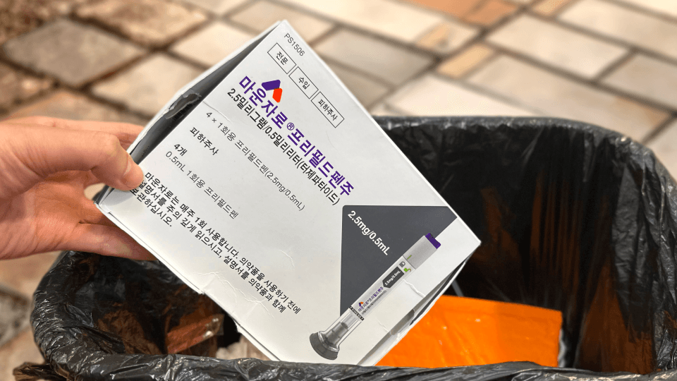 A photo of a used Mounjaro pen being tossed in the trash